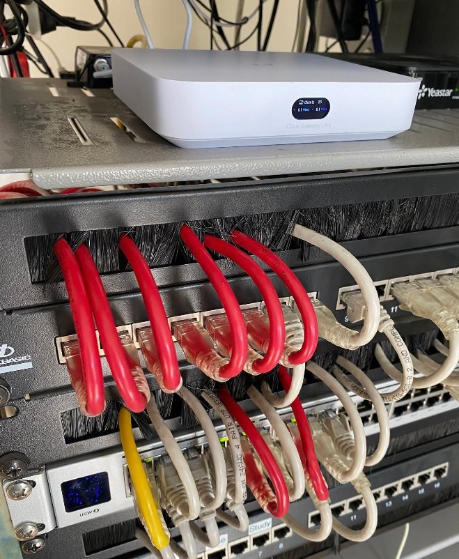 Colour-coded red and white patch cables looped neatly into a patch panel
